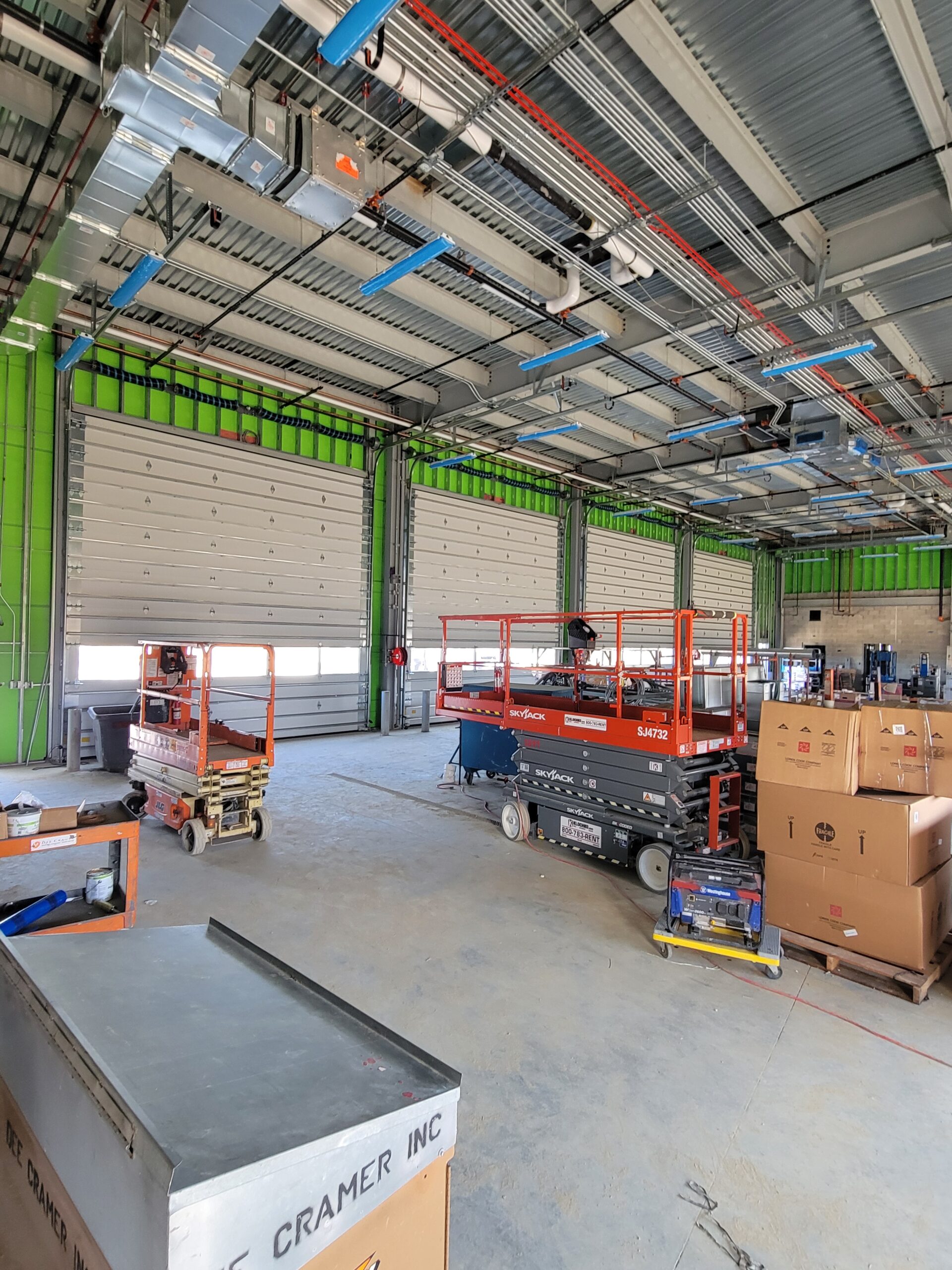 A warehouse with a lot of boxes and carts.